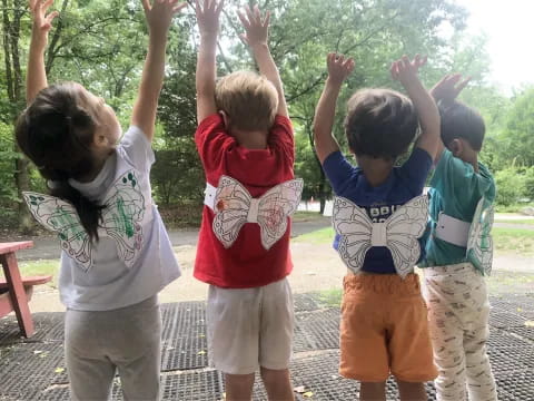 a group of children raising their hands