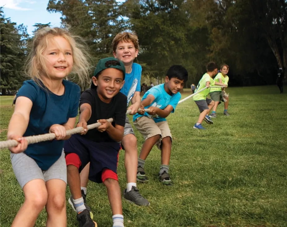 a group of kids playing with a stick