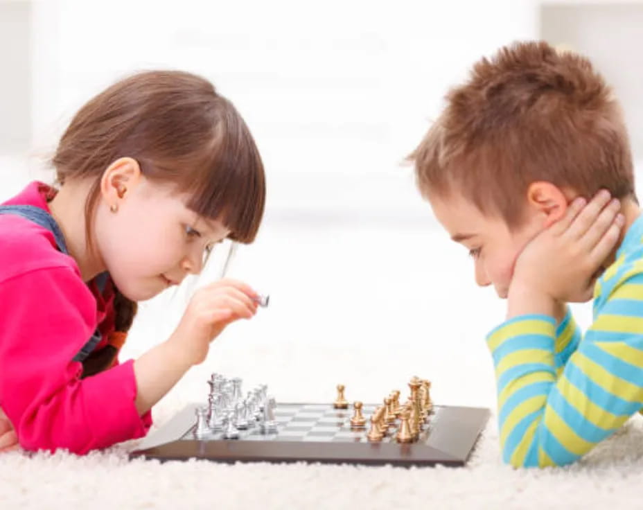 a couple of children playing chess