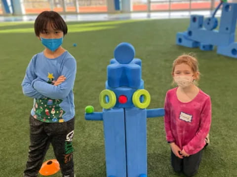 children standing next to a toy