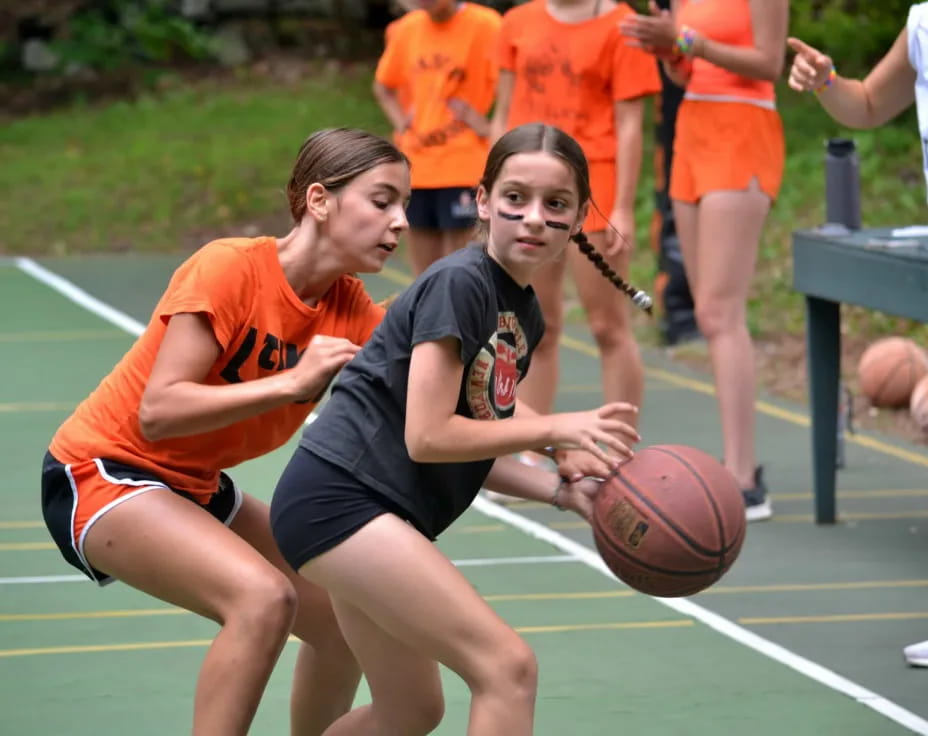 a couple of women playing basketball