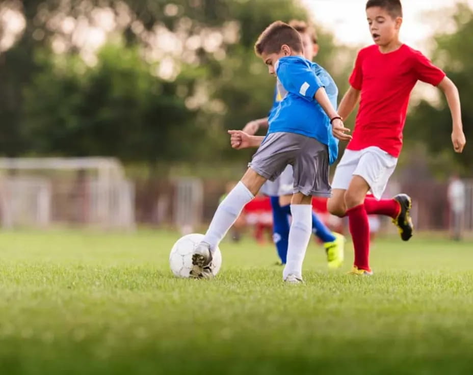 a couple of young boys playing football