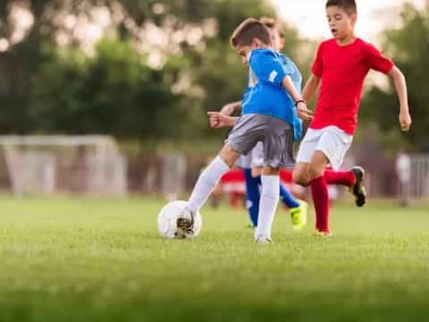 a couple of young boys playing football