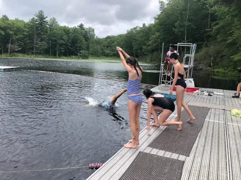 a group of women jumping into water
