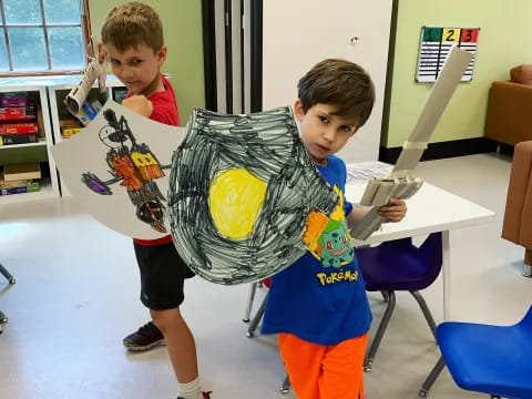 a couple of boys holding a sword