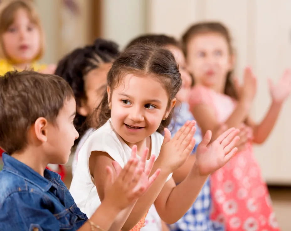 a group of children clapping