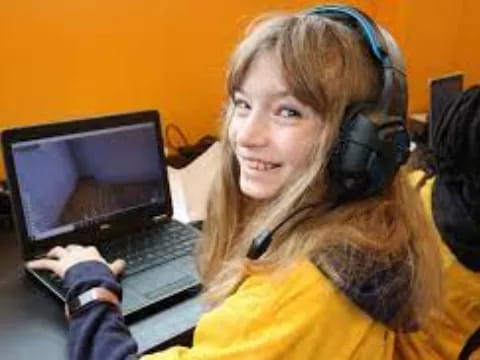 a person wearing headphones and using a laptop