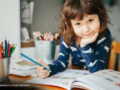 a young girl sitting at a table