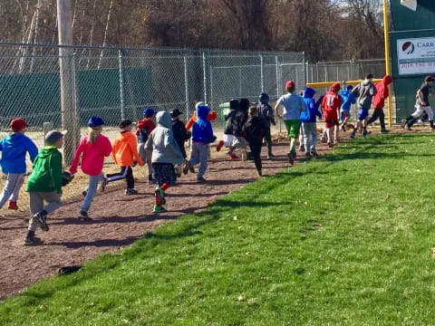 a group of kids running on a field