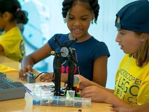 a few young girls working on a project