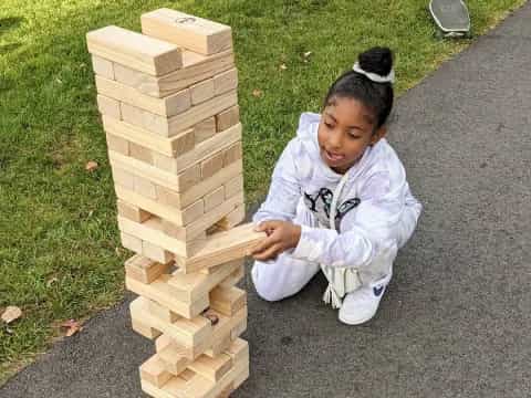 a girl playing with wooden blocks