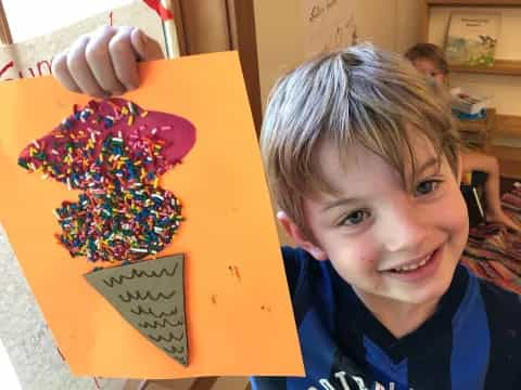 a boy holding a box of donuts