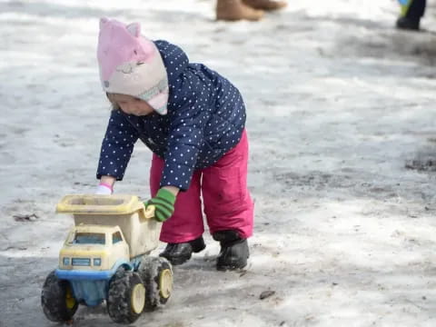 a child playing with a toy truck