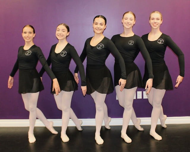 a group of women in black leotards