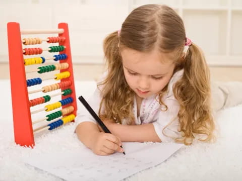 a girl coloring on a paper