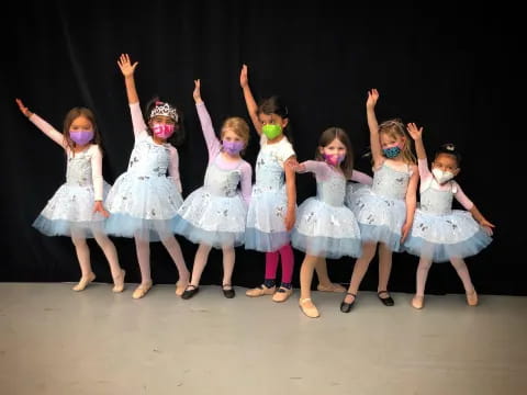 a group of girls in dresses