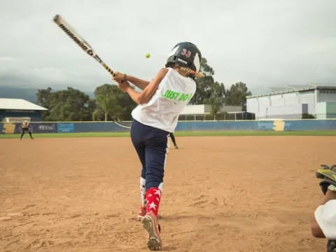 a person swinging a baseball bat