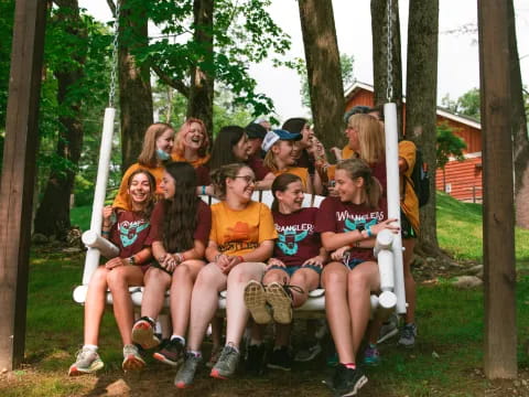 a group of people sitting on a bench in a park