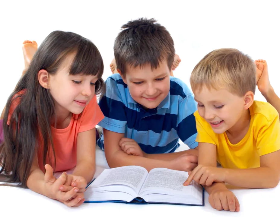 a group of children reading a book