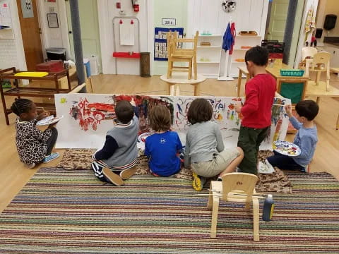 a group of children sitting on the floor reading books