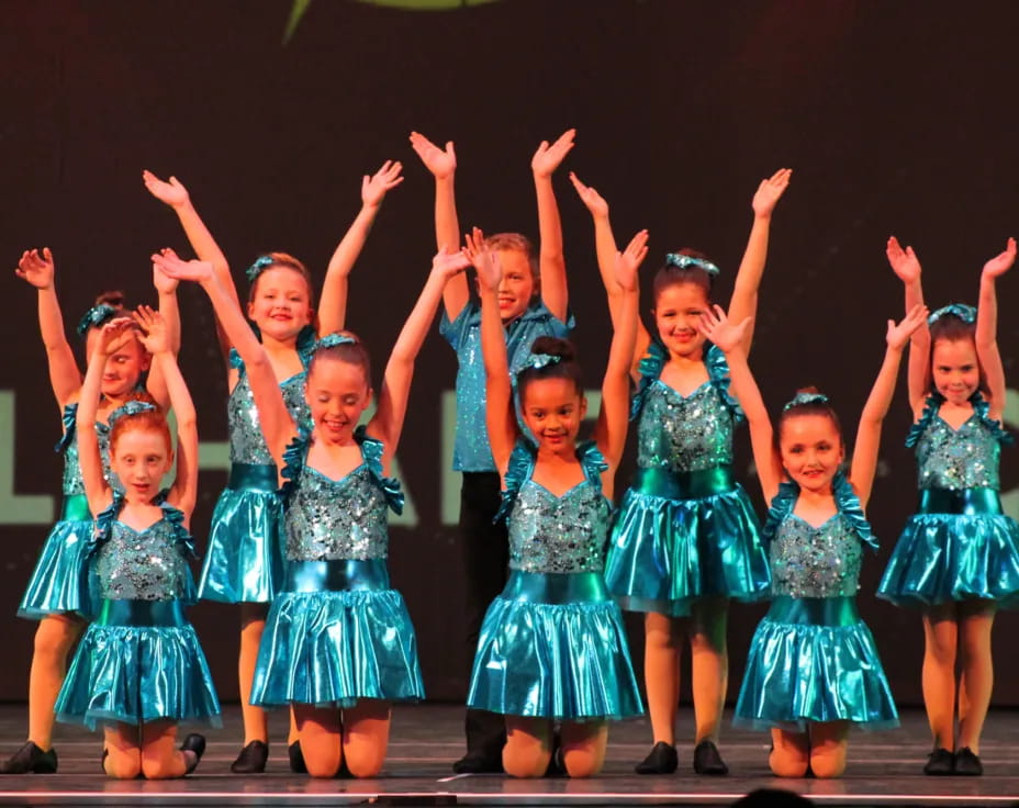 a group of girls in blue dresses