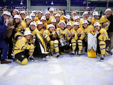 a group of hockey players posing for a photo