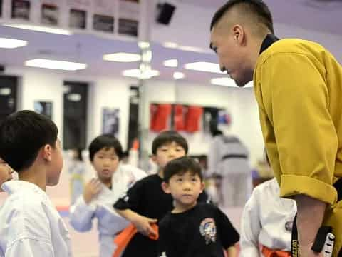 a man talking to a group of boys