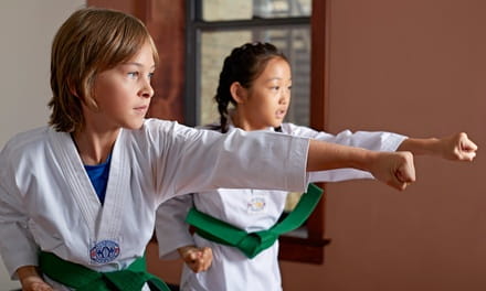 a couple of women in karate uniforms
