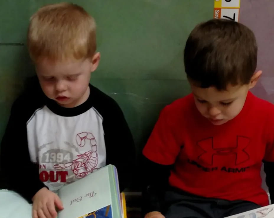 a couple of boys reading books