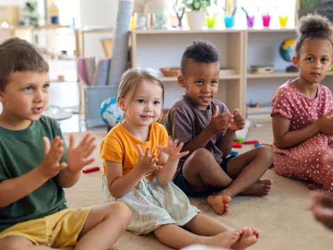 a group of children sitting on the floor