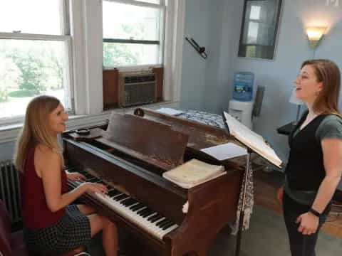 a woman playing a piano