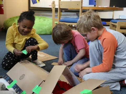 a group of children playing with a box