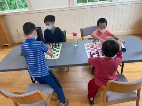 a group of people sitting around a table playing a game