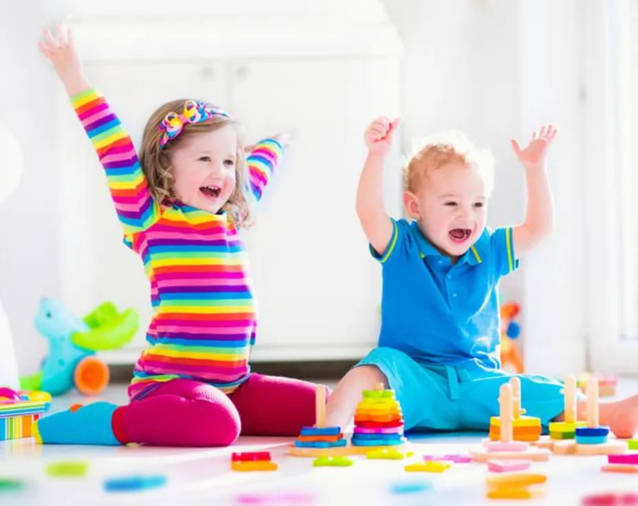 a couple of children playing with toys