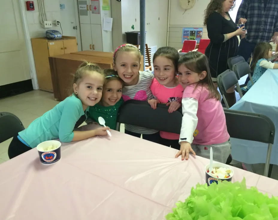 a group of children sitting at a table