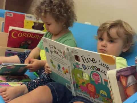 a couple of kids reading books