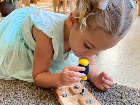 a girl playing with a toy