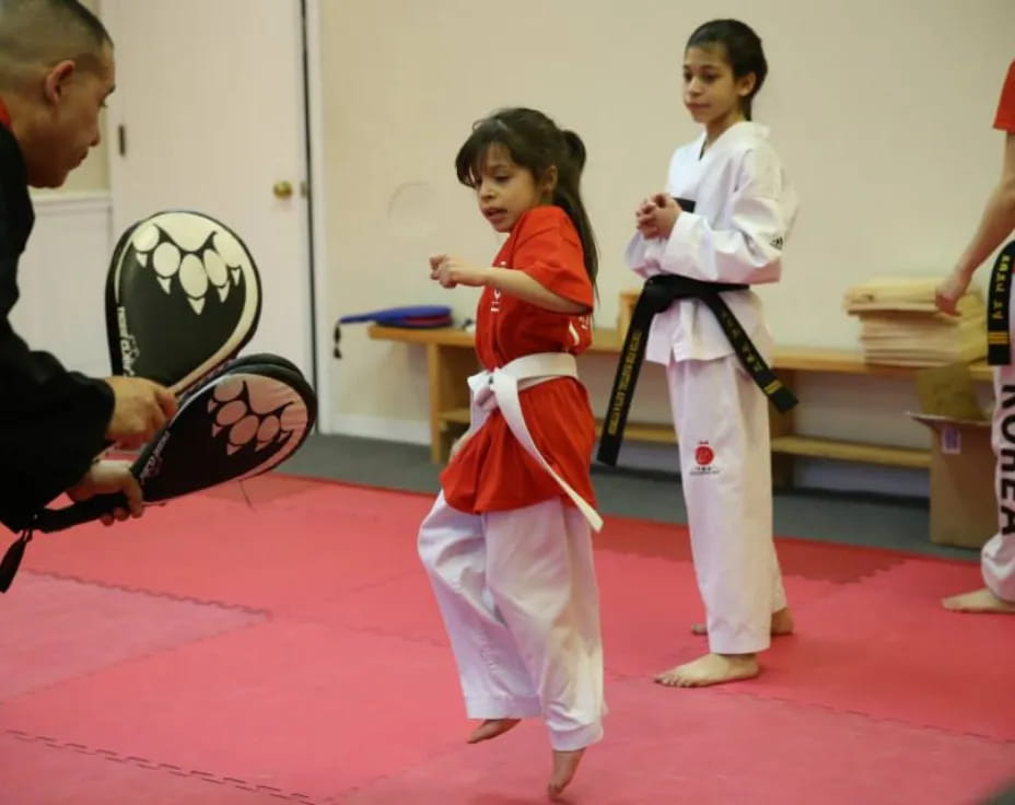 a group of people in karate uniforms