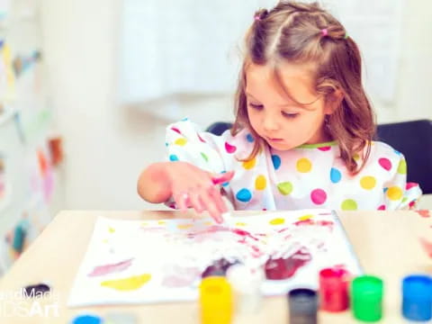a girl coloring on a paper