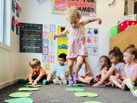 a group of children sitting on the floor in a classroom