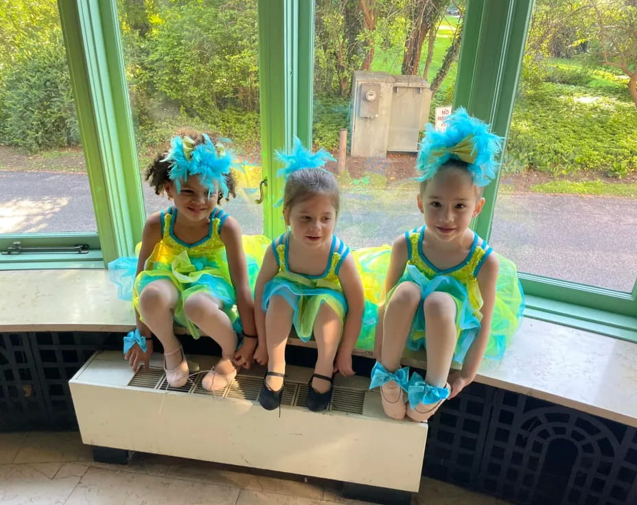 a group of children sitting on a bench