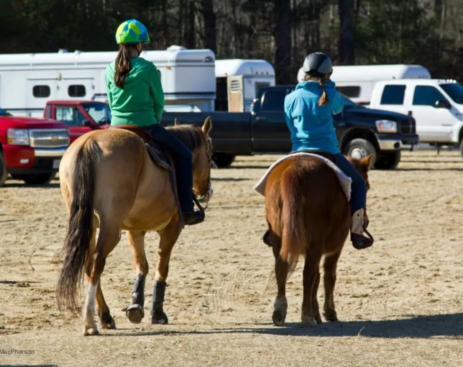 two girls riding horses