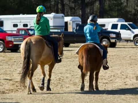 two girls riding horses