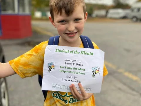 a boy holding a sign