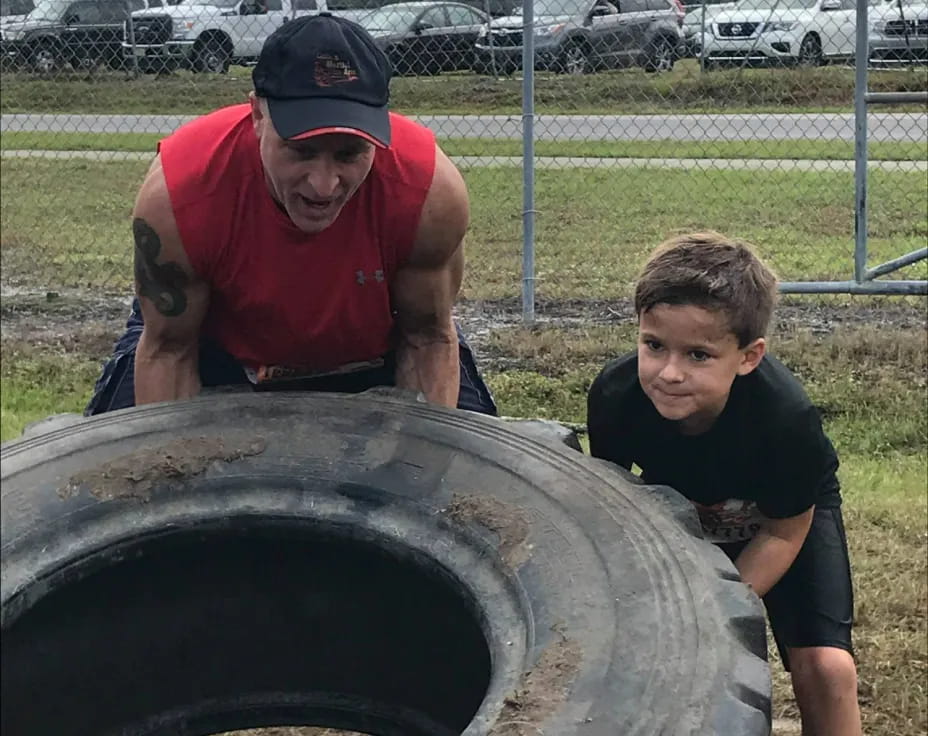 a man and a boy looking at a large metal object