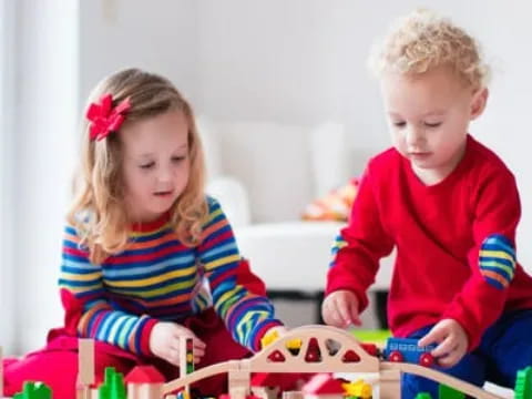 a boy and girl playing with toys