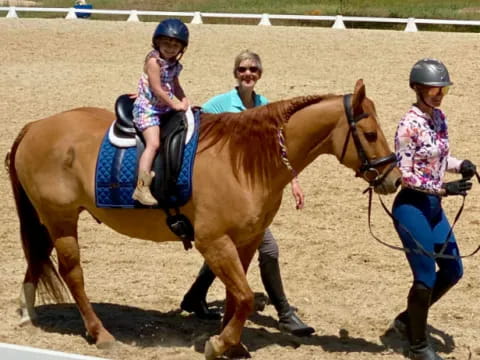 a group of people riding horses