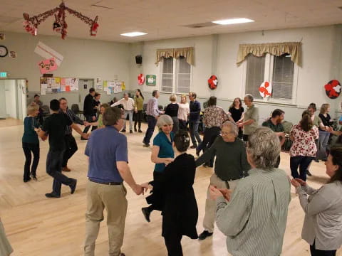 a group of people dancing in a room