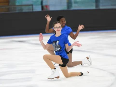 a man and woman ice skating