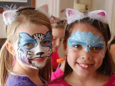 a group of girls with face paint
